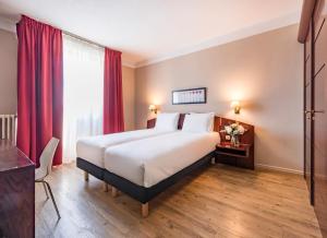 Postel nebo postele na pokoji v ubytování Le Grand Hotel