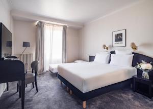 Postel nebo postele na pokoji v ubytování Le Grand Hotel