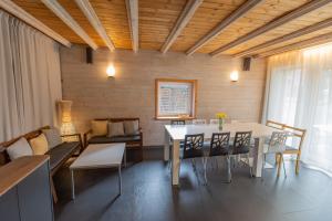a dining room with a white table and chairs at Beltes Guest House in Jūrmala