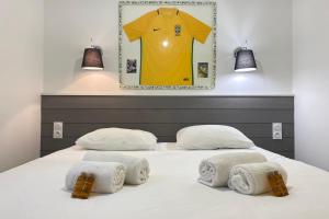 a bedroom with a bed with a jersey hanging on the wall at Villa Brésil - Domaine Le Sherwood in Notre-Dame-de-Monts