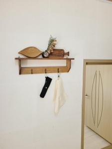 a shelf hanging on a wall with a door at Gyeongju Moon Rabbit in Gyeongju