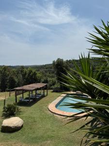 a backyard with a swimming pool and a pavilion at Can Masferrer in Riudarenes