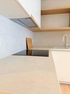 a kitchen with a sink and a counter top at Studio Nacre Knokke in Knokke-Heist +24 photos
