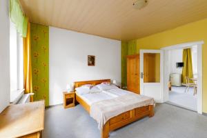 a bedroom with a bed and green walls at Resort Abertham - apartment Vanessa in Abertamy