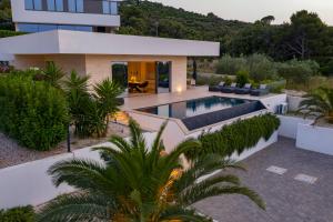 a house with a swimming pool in front of a building at Cloud 9 D10 in Tkon