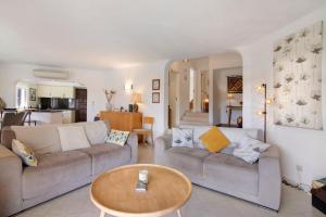 a living room with two couches and a table at Villa Rose in Albufeira