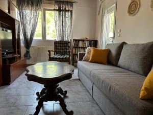 a living room with a couch and a table at Moustaki Apartments in Keramoti