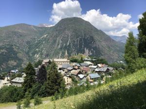 a small town in front of a mountain at Chalet Les Copains in Les Deux Alpes +19 photos
