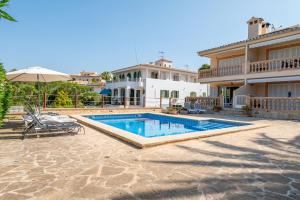 a swimming pool in front of a house at Apartment Soleado by Mallorca House Rent in Portocolom