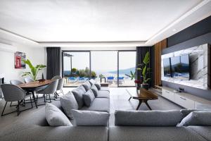 a living room with a large couch and a tv at Villa Upper House in Kas