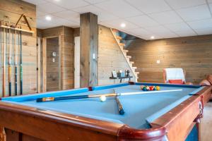 a blue pool table in a room with at L'Inukshuk - Chalet en bois ave Spa in Saint-Alexis-des-Monts