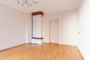 an empty room with white walls and wooden floors at Jasminu apartment in Jūrmala +1 photo