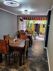a dining room with wooden tables and chairs at Hotel Villa Prats in Manuel Antonio
