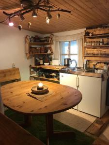 a kitchen with a wooden table in a room at Das wilde Auwaldhaus in Bertsdorf +15 photos