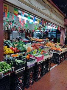 a market with a bunch of fruits and vegetables on display at CASA FRONTE MARE in Ventimiglia