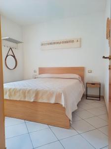a bedroom with a large bed in a white room at La Tortuga in Rena Majore