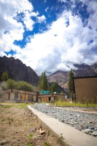 a house on the tracks with mountains in the background at The Khama in Hundar +6 photos