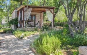 a tiny house in the woods with a porch at Olive in Rovinj