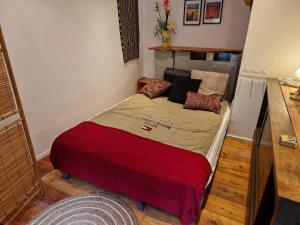 a small room with a bed in a room at Gites Amorique Plesidy in Plésidy