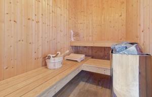 an inside of a wooden sauna with a bucket at Dünenpark 2B - Dorf 4 in Priwall