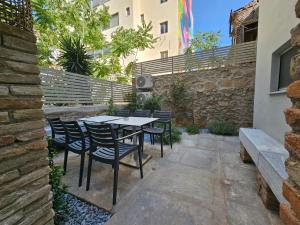a patio with a table and chairs and a building at Silk Suites by YHA in Athens