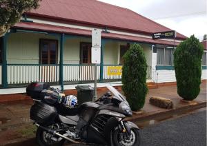 a motorcycle parked in front of a building at The Kumbia Hotel in Kumbia