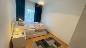 a small bedroom with a bed and a window at Ibolya Nyaralóház Fonyód in Fonyód