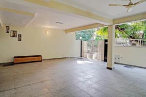 an empty living room with a ceiling fan at Super Hotel O Golden Imperial in Noida