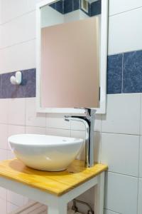a bathroom with a white sink and a mirror at Hotel PUERTO A in Gualeguaychú +32 photos