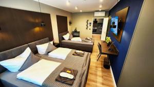 a hotel room with two beds and a couch at Liro Hotel Mönchengladbach in Mönchengladbach
