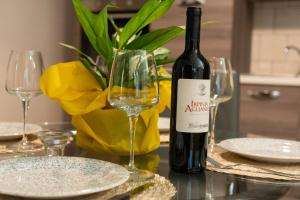 a bottle of wine and two glasses on a table at Vicolo del Sole in Santo Stefano del Sole