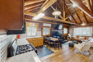 a kitchen and living room with wooden ceilings at Cowboy Cabin in Pinetop-Lakeside