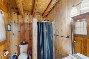 a wooden bathroom with a toilet and a shower at Cowboy Cabin in Pinetop-Lakeside +20 photos