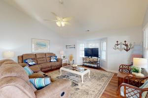 a living room with a couch and a tv at Pops Place in Atlantic Beach