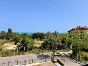 two yellow cars parked on the side of a road at Sea View Apartment in Aurora Complex, Steps from the Beach in St. St. Constantine and Helena