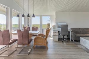a living room with a table and chairs and a couch at Schimmelreiter in Simonsberg