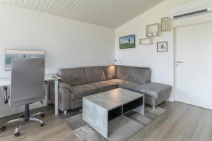 a living room with a couch and a table at Schimmelreiter in Simonsberg