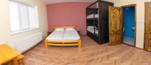 a bedroom with a bed and a wooden floor at Dream Hostel Carpathians Rakhiv in Rakhiv +25 photos