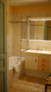 a bathroom with a tub and a sink and a shower at Château de la Gabelle Férrassières in Ferrassières