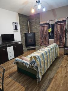 a living room with a bed and a fireplace at Casa Sol in Carrapateira