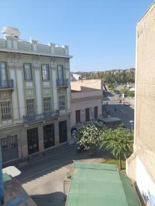a building with a green awning in front of a street at SHARING ROOM IN NEAR THISSIO METRO STATION BY ACROPOLIs in Athens