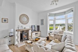a living room with a couch and a fireplace at River Retreat in Kingswear