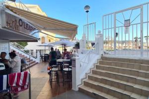 a restaurant with stairs and people sitting at tables at Joy & Friends 1 in Los Cristianos