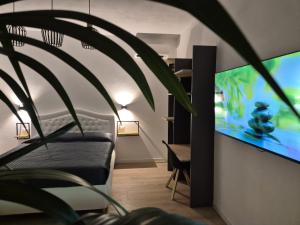 a bedroom with a bed and a flat screen tv at Superior Suite, Villa Joy Verona, Luxury Romantic Suite with Jacuzzi, near City Center in Verona