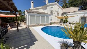 a swimming pool in the backyard of a house at Villa with Private Pool & Hot tub in Fortuna
