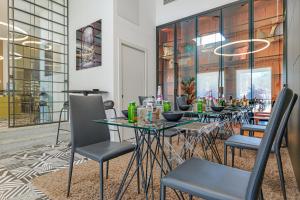 a group of tables and chairs in a restaurant at HOTIDAY Olbia Wallure in Olbia