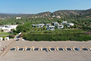 a group of chairs sitting on top of a beach at Niriides Beachfront Resort in Gythio +54 photos