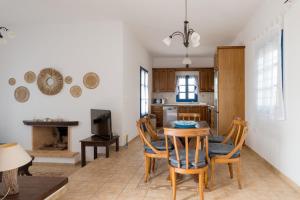 a kitchen and dining room with a table and chairs at Traditional Cycladic Home Paros in Naousa