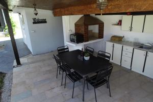 a kitchen with a black table and chairs in a room at Villa Petrovic in Fažana