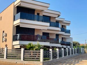 a building with a fence in front of it at Galatea Suites in Kalyves Poligirou